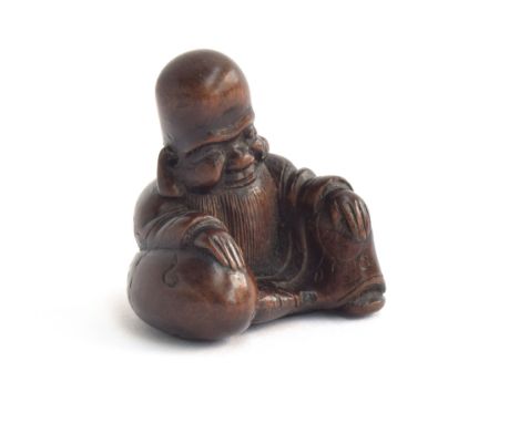 A Japanese carved netsuke in the form of a sage, makers mark to base, 4cm high 
