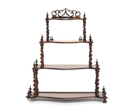 A Victorian rosewood four tier whatnot, each shaped shelf on barleytwist supports, 68cm wide, 77cm high 