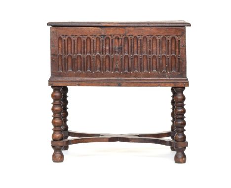 A 17th century oak bible box, on later bobbin turned stand, 66cm wide, 43cm deep, the box 29cm high, overall 65cm high 