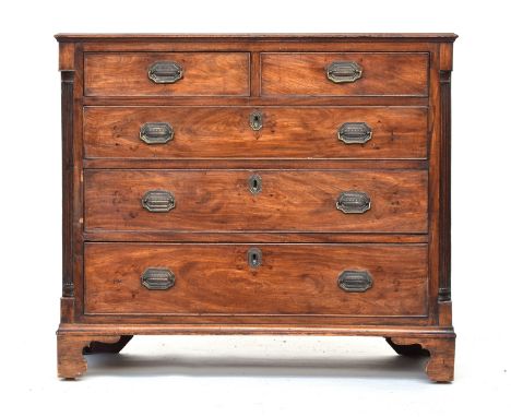 A George III mahogany chest of two short over three graduating drawers, the drawers flanked by reeded ionic quarter columns, 