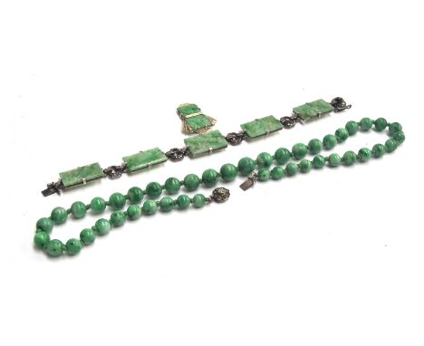 A jade bead necklace, knotted between each bead, with a paste set sterling silver clasp in the form of a flower, 44cm long; a