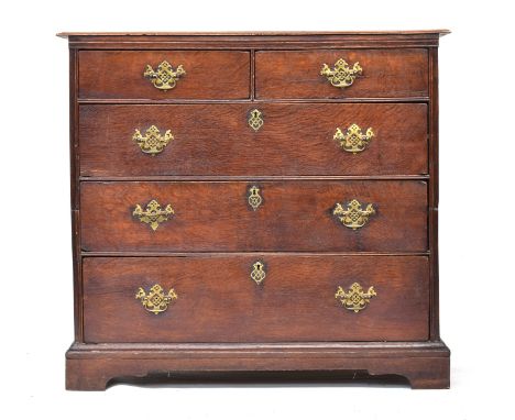 A George II oak chest of drawers, the moulded two plank top over two short and three long drawers within a moulded carcass, o