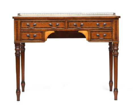 An Edwardian kneehole desk, brass gallery, tooled green leather skiver, over four cross banded drawers and marquetry spandrel