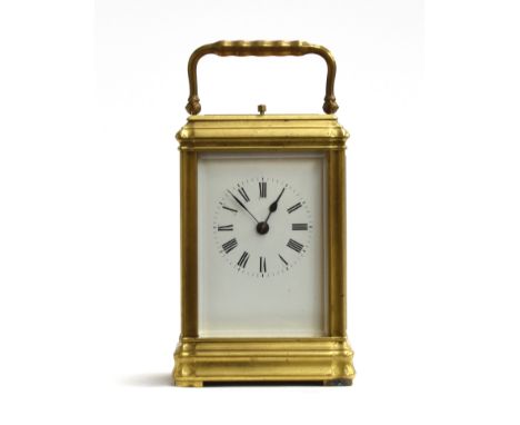 A brass carriage clock with bevelled glass and white enamel dial and Roman numerals, repeat mechanism, approx. 14cm high