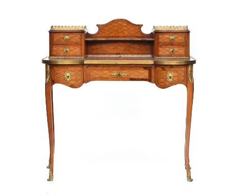 A Continental ormolu desk, having superstructure with two piers each of two drawers, the gilt metal banded top over a further