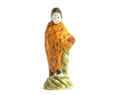 An 18th century Astbury-Whieldon figure of a woman with mustard glaze dress holding flower basket, c.1745, 11.5cm high 