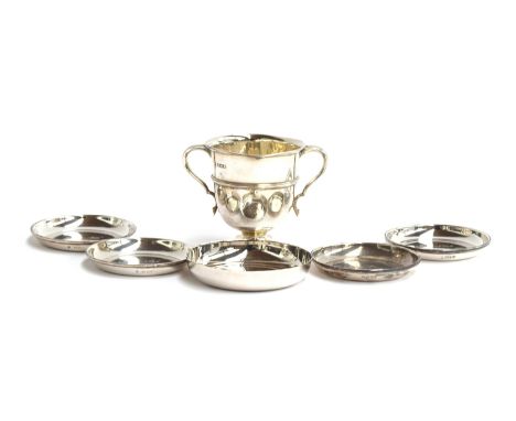 A small twin handled trophy cup by William Hutton &amp; Sons Ltd, 8cm high; together with four silver pin dishes awarded as B