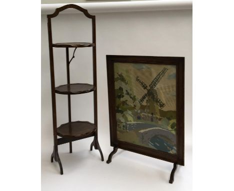 An embroidered fire screen, 65cmH; together with a folding oak three tiered cake stand, 94cmH 