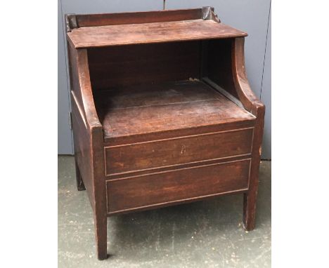 An early 19th century oak commode/bedside cabinet, with two hinged tiers 