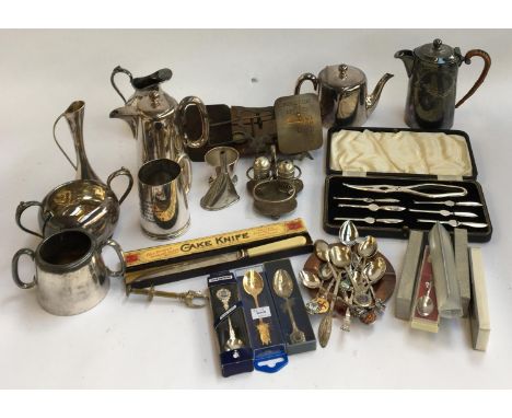 A mixed lot of plated wares to include a cased set of lobster picks, several coffee sets, a number of crested spoons, a set o