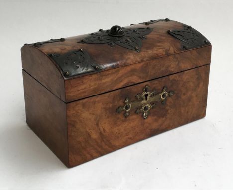 An early 20th century walnut tea caddy, domed top with single stone and pierced metal decorations, 23cmW 
