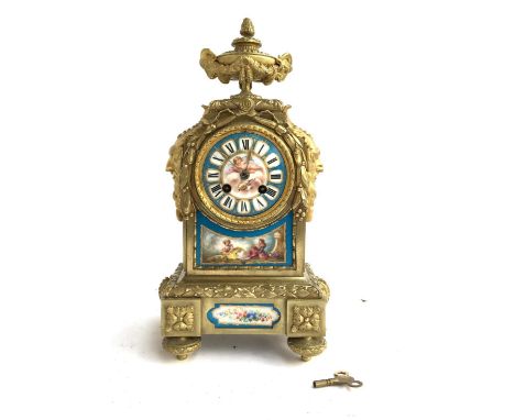 A French brass mantel clock, movement marked H &amp; F Paris, with Watteau style panels and Greenman masks, with key, 36cmH