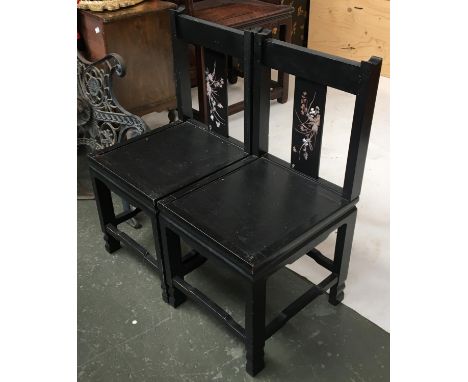 A pair of black lacquered and mother of pearl inlaid occasional chairs 