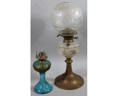 An Edwardian oil lamp, with frosted globular shade, brass mounts, glass reservoir and inverted stem, 55cm high, and another m