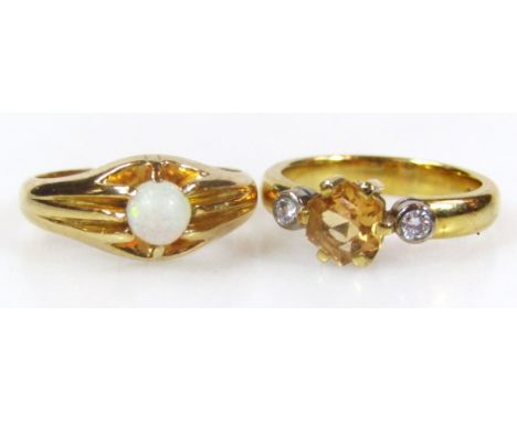 A ladies dress ring, centred with an opal on part pierced shank, marked 18, size J-K, and a citrine and diamond ring, marked 