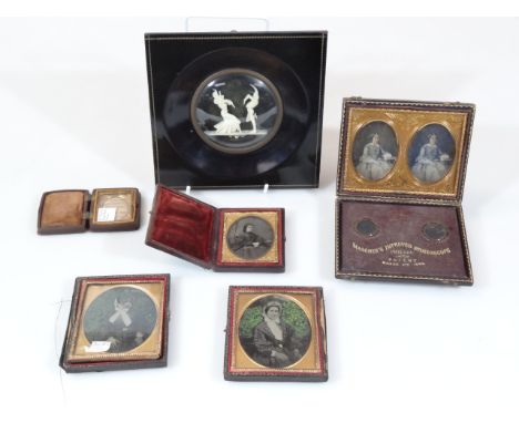 A hand held Mascher's Improved Stereoscope, patented for 1853, with image of lady, with articulated case, 12cm wide, a miniat