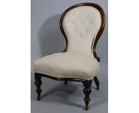 A Victorian mahogany spoon back open armchair, with button back and serpentine seat (and later) floral material, on turned fr