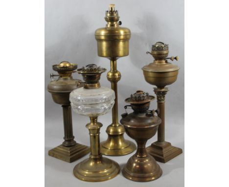 Various Edwardian and later brass lamp bases, to include one with glass reservoir, with metal mounts on cylindrical stem and 