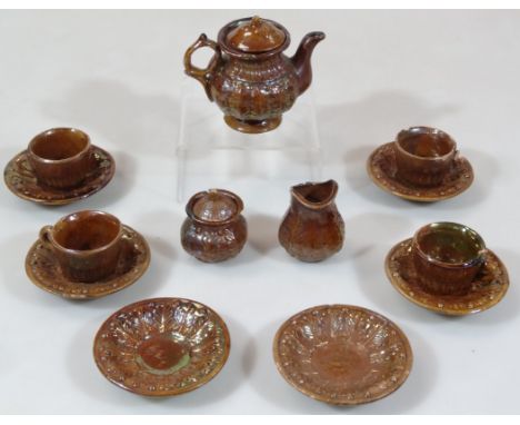 A 19thC lustre stoneware child's tea service, comprising teapot, 6cm high, and four cups, six saucers, lidded sugar bowl and 