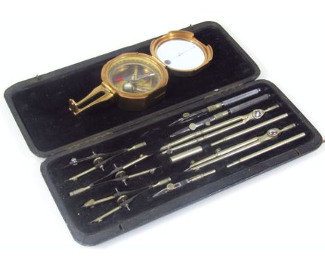 A Stanley of London Natural brass compass, with articulated lid within a glass top and fitted interior, 8cm wide, and a part 