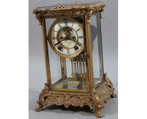 An early 20thC rococo design mercury pendulum clock, with 12cm. dia. Roman numeric dial, visible cog work and eight day movem