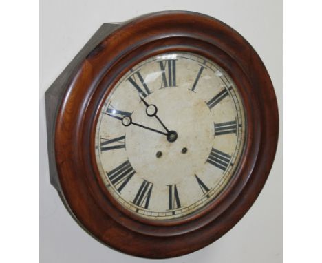 An early 20thC mahogany cased wall clock, the 31cm dia. dial with Roman numerals revealing an eight day movement, in carved c