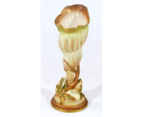 A Royal Worcester blush ivory shell vase, picked out in green and gilt on a naturalistic base on circular foot, number 2531, 