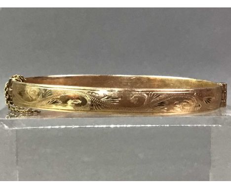 ROLLED GOLD BANGLE with engraved decoration