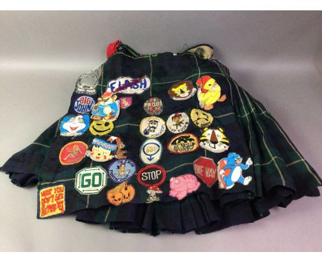 PUNK THEMED TARTAN KILT with various stitched labels including 'Flash', a light bulb, 'Fly United' and others