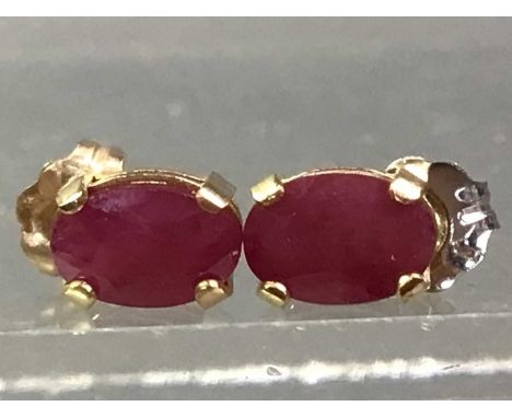 TWO PAIRS OF GEM SET STUD EARRINGS one sapphire, the other ruby, each marked 10K