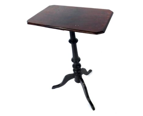 An early 20thC mahogany table, the rectangular top with canted corners on a turned column and tripod base, 70cm high, 28cm wi