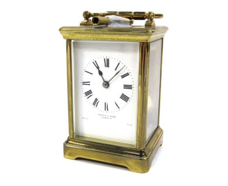 A gilt brass carriage clock, with white enamel dial, Roman numeral, chapter ring, marked Mappin &amp; Webb London, French mad