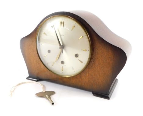 A Smith's oak cased mantle clock, the domed top above a silvered coloured dial, with gold point markers and hands, 21cm high,