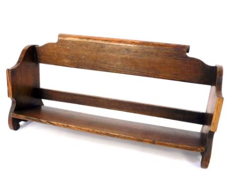 An oak book trough, with scroll back, 24cm high, 58cm wide, 14cm deep. 