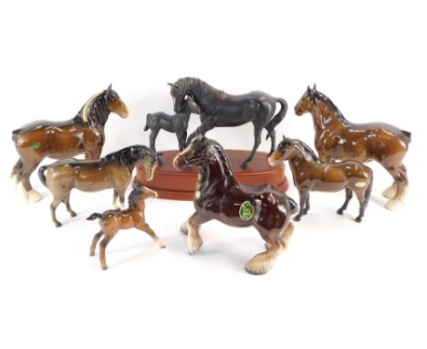 A group of horse figures, comprising a Royal Doulton Black Beauty and foal, on a raised base, a Melba ware shire horse, two B