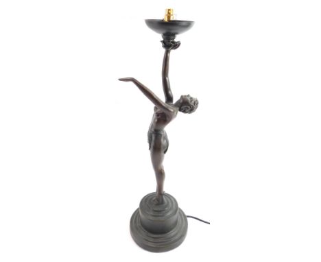 A bronzed plaster figural table lamp, modelled as a female exotic dancer, lacking shade, 54cm high. 