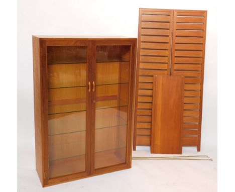 A quantity of Ladderax style teak furniture, comprising wooden shelves, and a two door display cabinet with five glass shelve