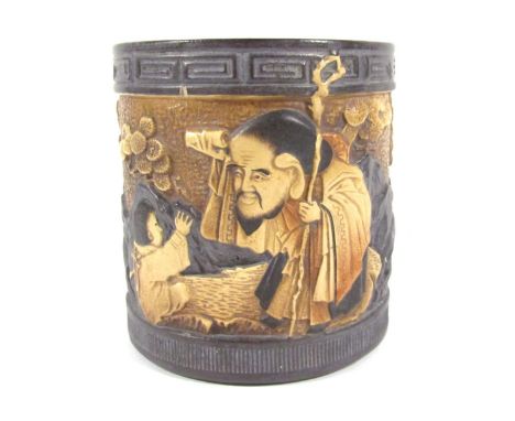 A Bretby planter, on black ground with Oriental figures and flowers, stamped to underside, 22cm high. (AF)