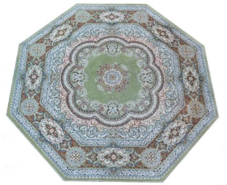 An Eastern octagonal rug, on a light green ground with floral centre and outer border, 245cm diameter. 