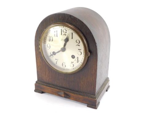 An early 20thC oak cased mantel clock, with silver numeric dial marked Harvey's of Spalding, bearing Arabic numerals, German 