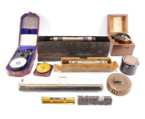 A group of miscellaneous military and measuring effects, a brass spirit level, leather tape measure, a Howden Calculex compas