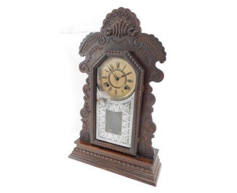 An early 20thC Vienna mahogany mantle clock, the arched top with shell and scroll finial, on a painted dial marked Ansonia cl