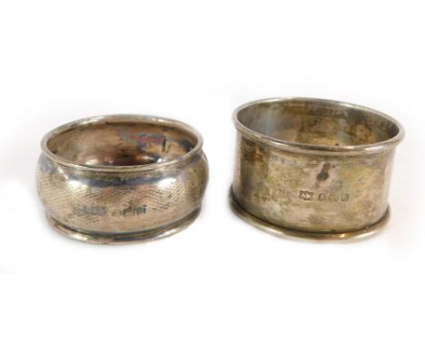 Two silver napkin rings, one with engine turned decoration, the other of plain design, ½oz. (2)