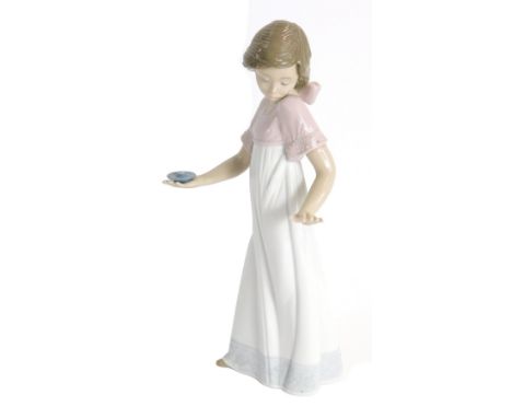 A Nao porcelain figure of a girl carrying a candle stick, 25cm high. (AF)