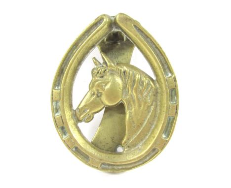 A brass horse shoe and horse head door knocker, 12cm high.