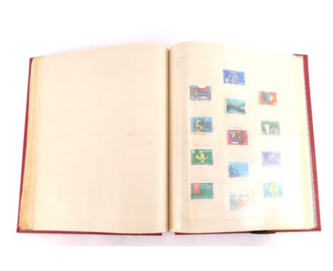 Philately. A world stamp album, containing GB GV-EII commemoratives and definitives, Empire and Commonwealth and world stamps