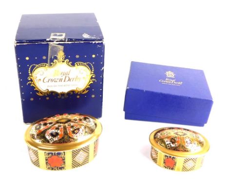 Two Royal Crown Derby porcelain Old Imari trinket boxes and covers, of oval form, printed marks, boxed. 