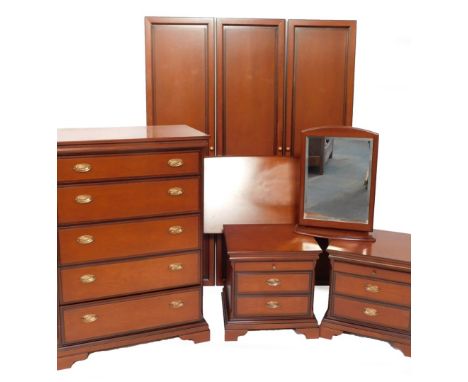 A Stag cherry veneered bedroom suite, comprising chest of drawers, two bedsides, dressing table mirror and a triple wardrobe,