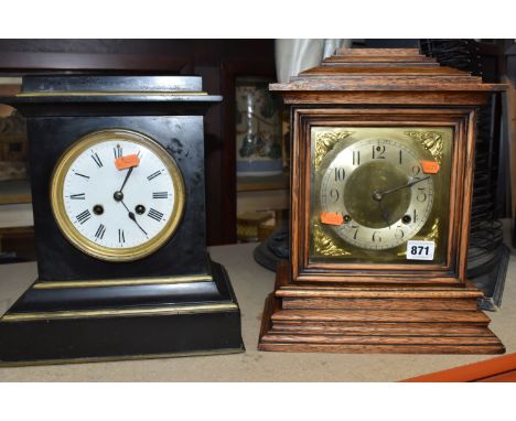 TWO MANTEL CLOCKS, comprising a black slate stepped case French mantel clock, the white circular dial covered by a bevel edge
