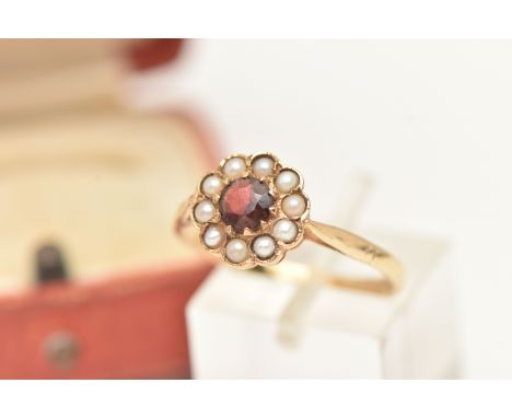 A 9CT GOLD GARNET AND SPLIT PEARL CLUSTER RING, circular cluster set with a central circular cut garnet within a surround of 